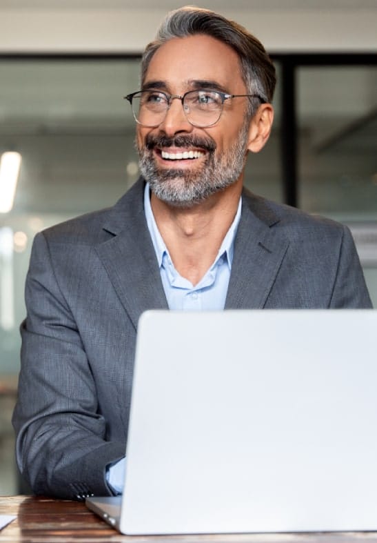 Business man smiling with laptop